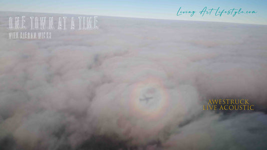 Awestruck by Kieran Wicks Live Acoustic Rendition - Plane shadow in clouds with a rainbow ring surrounding it Room with a View Aerial Photography