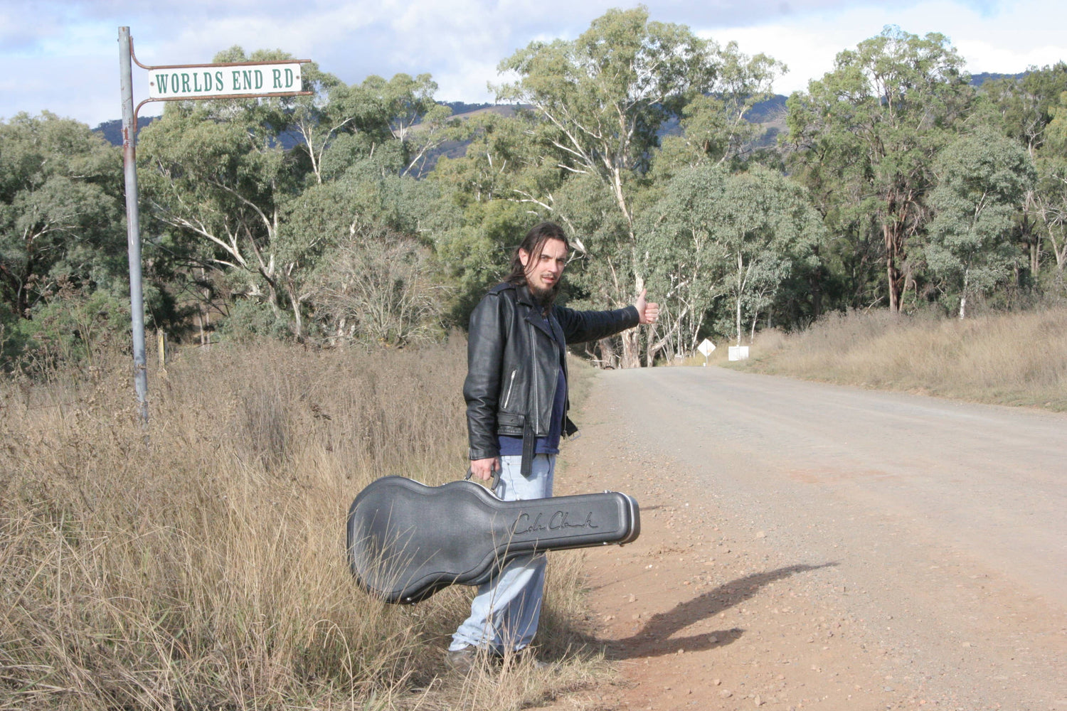 Kieran Wicks Musician Hunter & King Album Cover Kieran Wicks Hitch Hiking with cole clark guitar. Country Dirt Road street sign Worlds End Road Leather Jacket